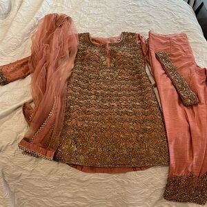 Dusty pink salwar set with heavy stone work. Stone work also on pants and belt
